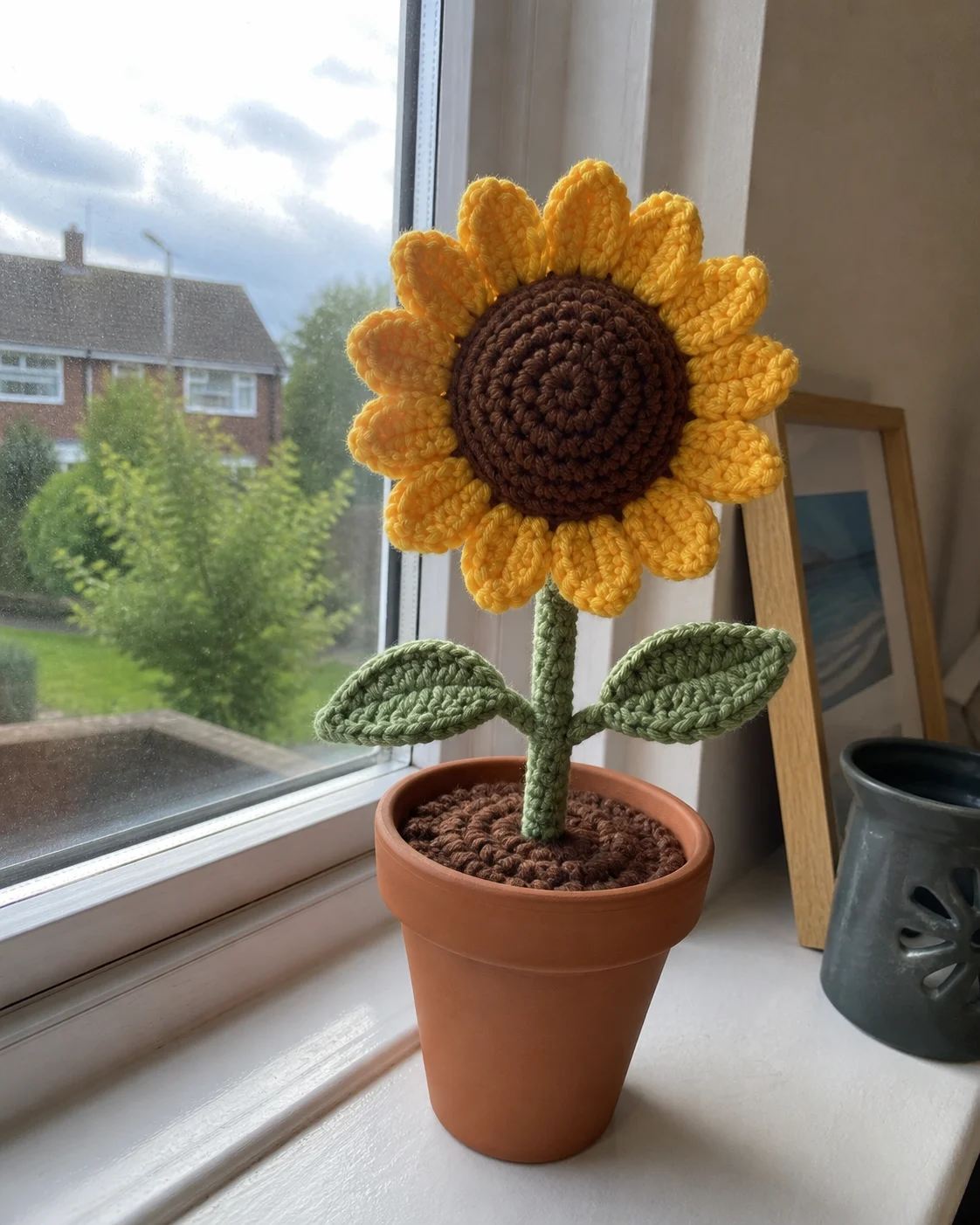 Crocheted flower with layered petals worked in soft cotton yarn