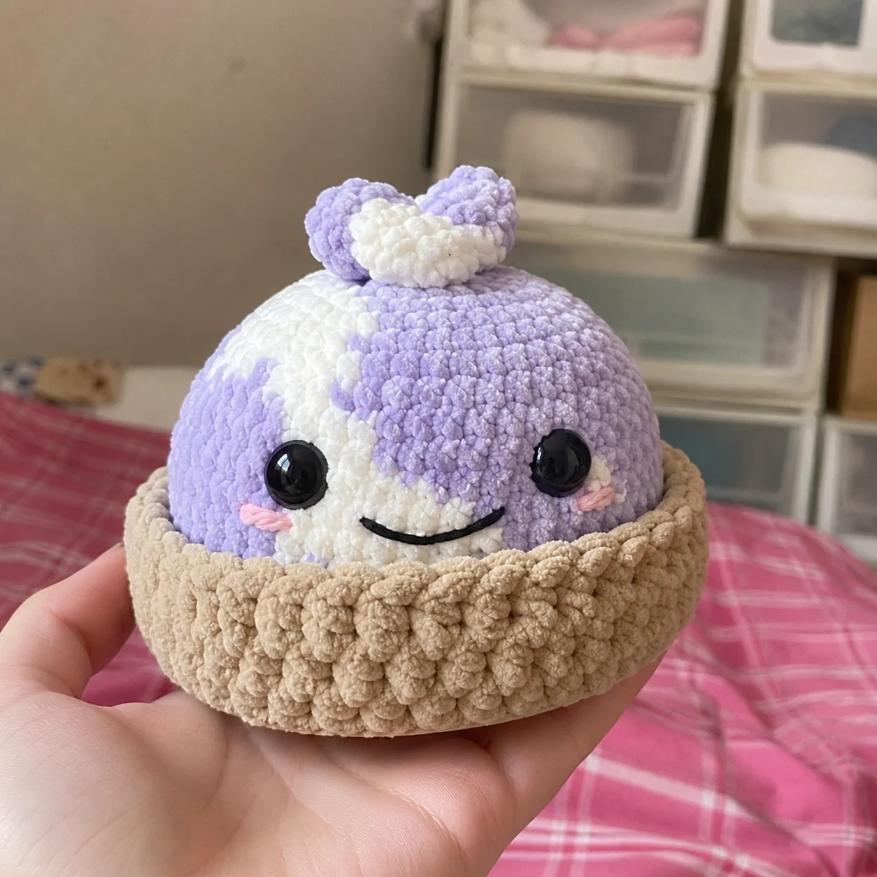 Soft crocheted dumpling plushie held in one hand