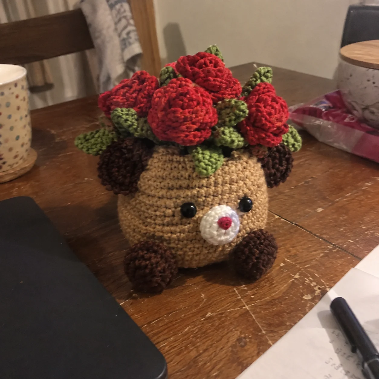 Handmade critter planter pot amigurumi displayed on a shelf