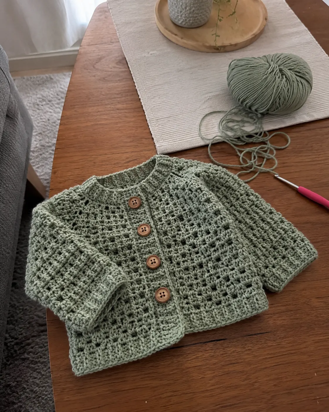 Set of crocheted baby items arranged as a gift