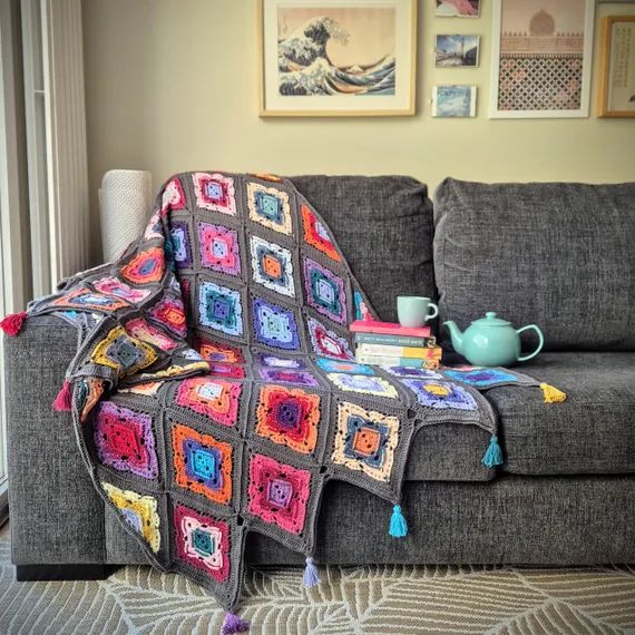 Chevron ripple crochet blanket folded on a chair